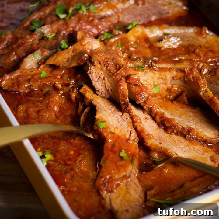 A pan of braised beef brisket, hot from the oven and ready to eat.