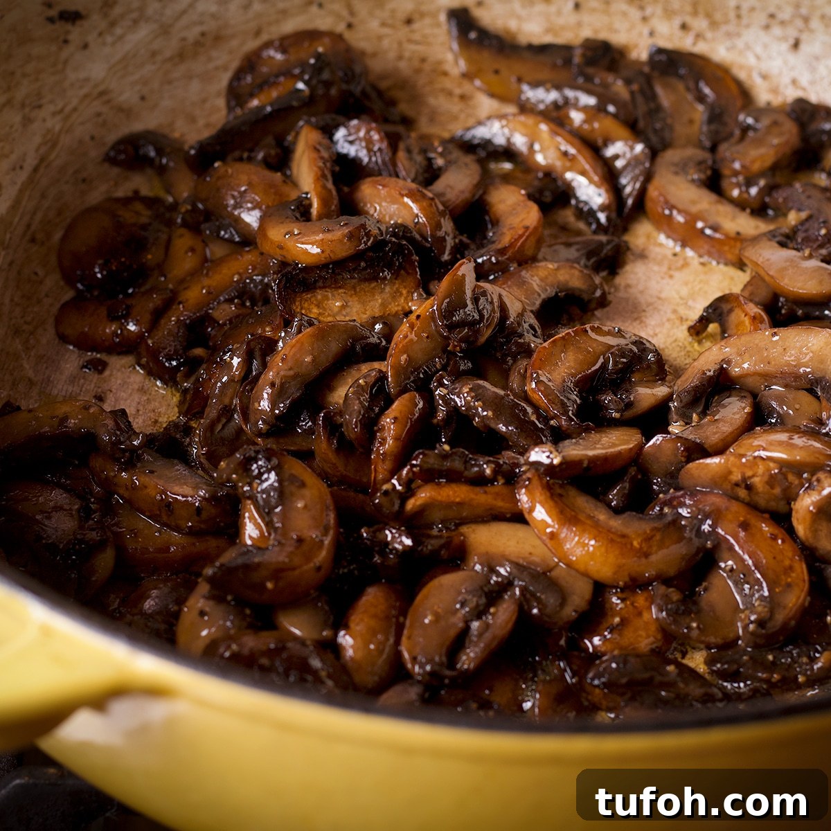 Creamy Mushroom Chicken with Parmesan Rice Bowl 6 Sliced mushrooms cooking in butter and oil in a large sauce pan.