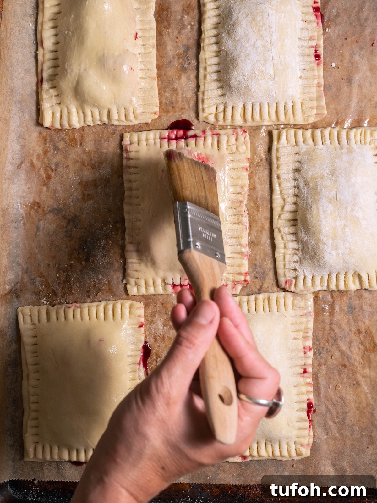 Brushing hand pies with egg wash