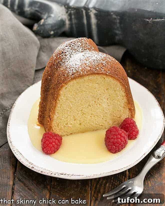 White Chocolate Bundt Cake Flavored with vanilla and a touch of almond, this glazed Bundt cake is a winner! Slice of white chocolate pound cake on a dessert plate with raspberries and white chocolate sauce.