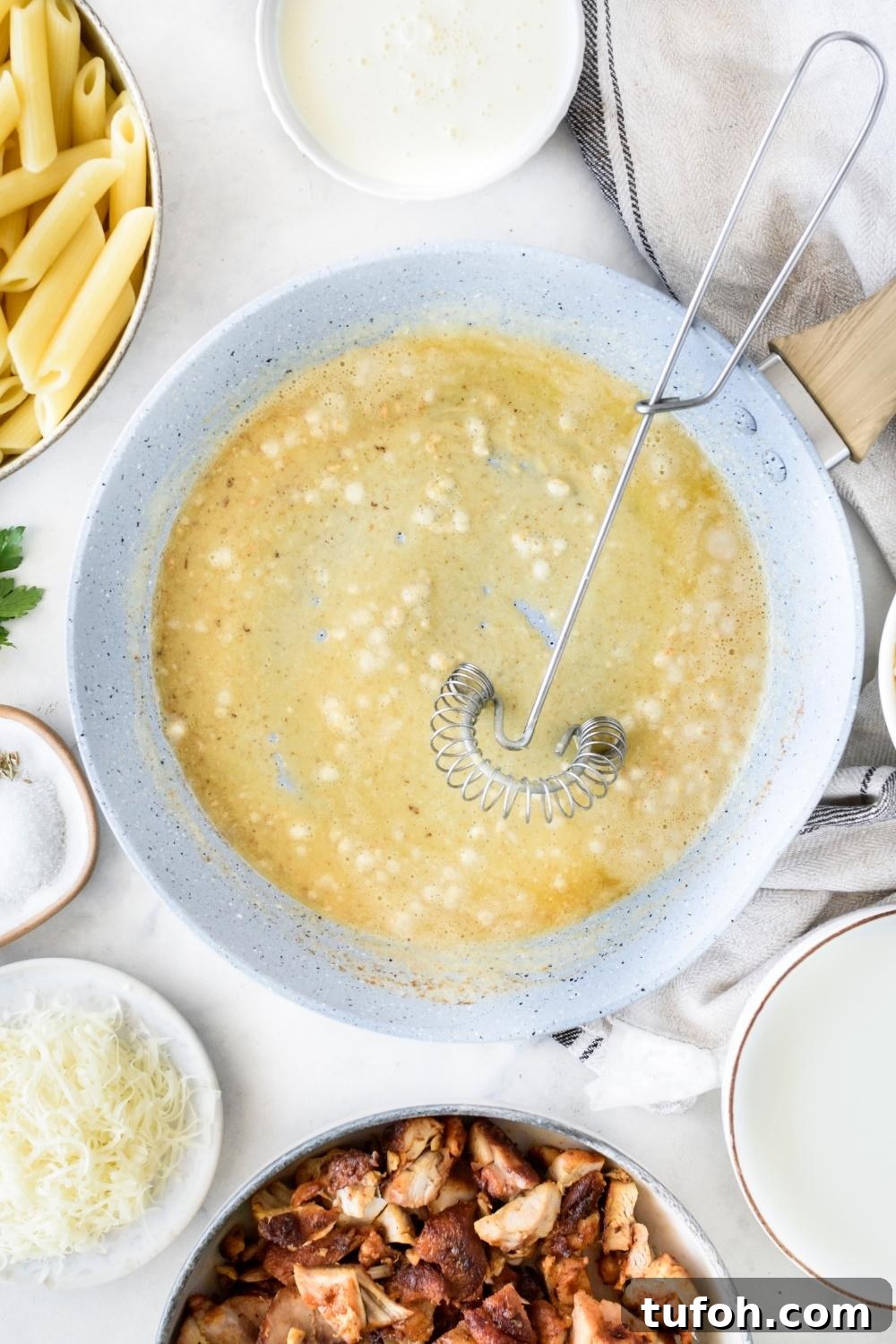 A skillet with garlic and butter being cooked.