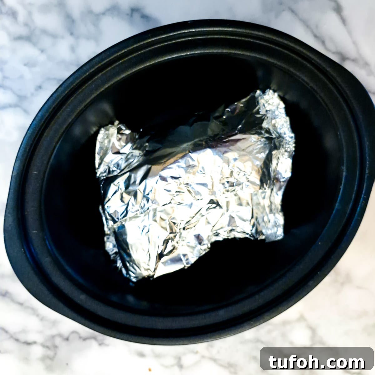 Slow-Cooked Curried Leg of Lamb in Foil for Tender Flavor 10 Foil-wrapped leg of lamb in the slow cooker.