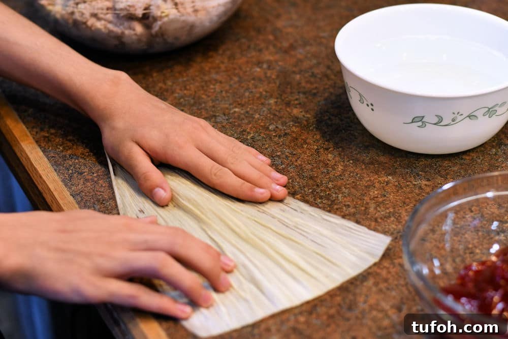 Raspberry Sweet Tamales Recipe: Decadent Mexican Dessert 4 24Bite: spreading corn husk to begin making raspberry tamal