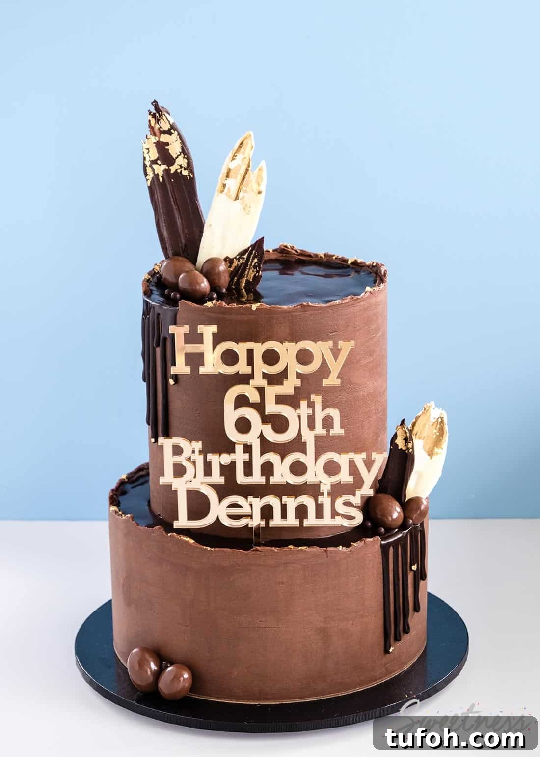 How to Make a Rough-Edge Ganache Drip Cake: Step-by-Step Tutorial 4 A two tier chocolate ganache covered cake with ganache drips and a gold happy birthday cake topper.