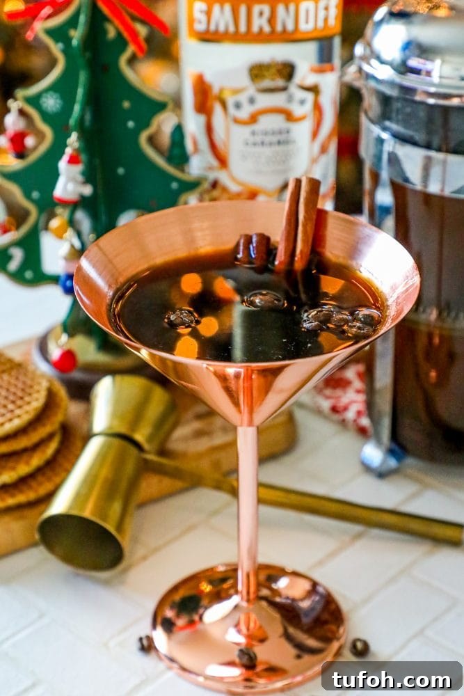 brass martini glass with coffee beans and cinnamon sticks in it