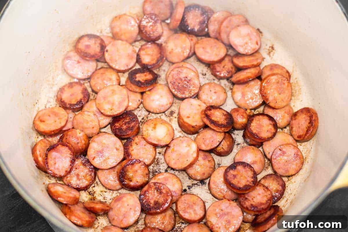Cooking andouille sausage in Dutch oven.
