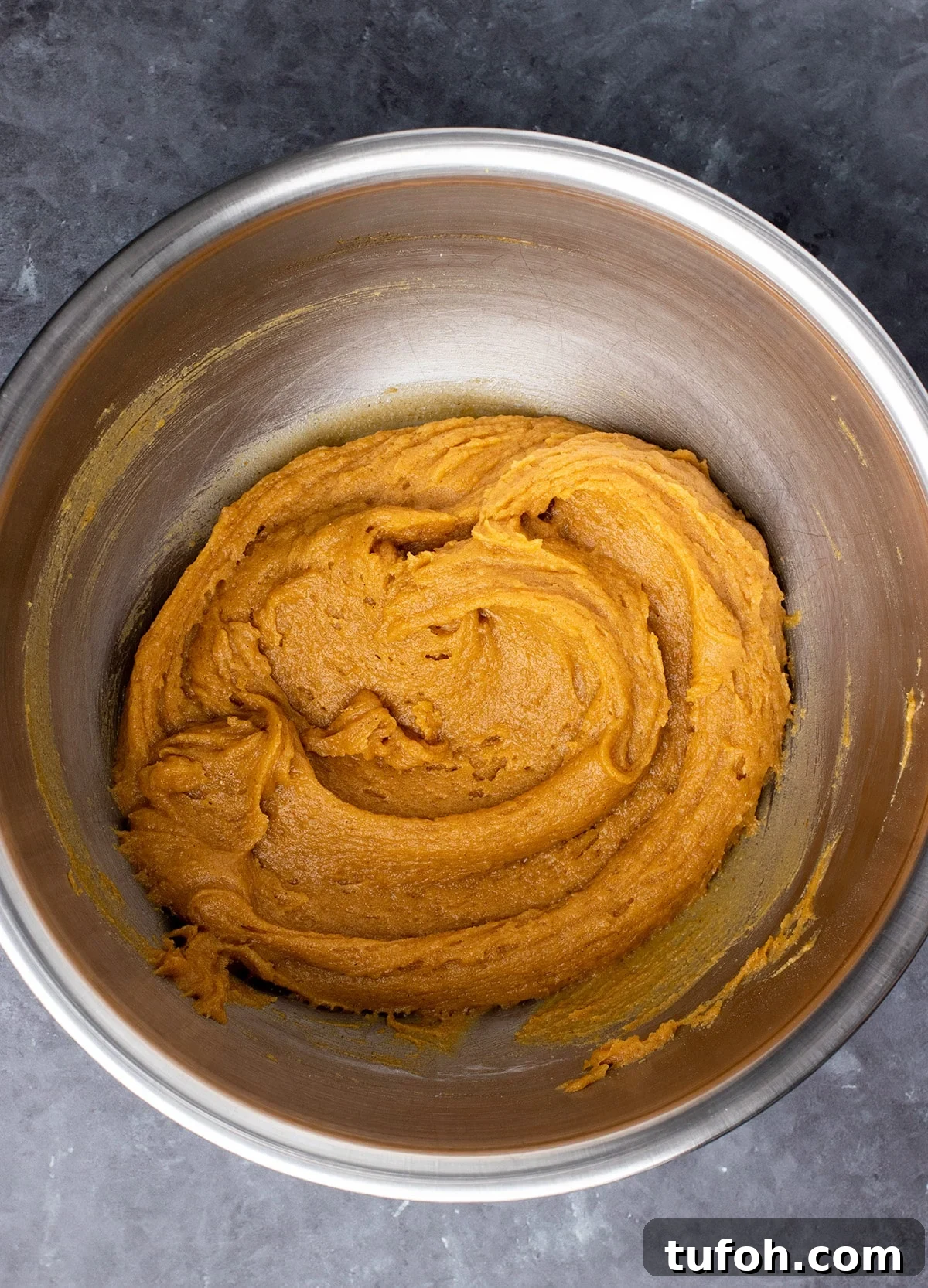 Gluten-Free Pumpkin Cookie Recipe: Soft, Chewy Fall Treat 4 Orange colored cookie batter in large metal mixing bowl.