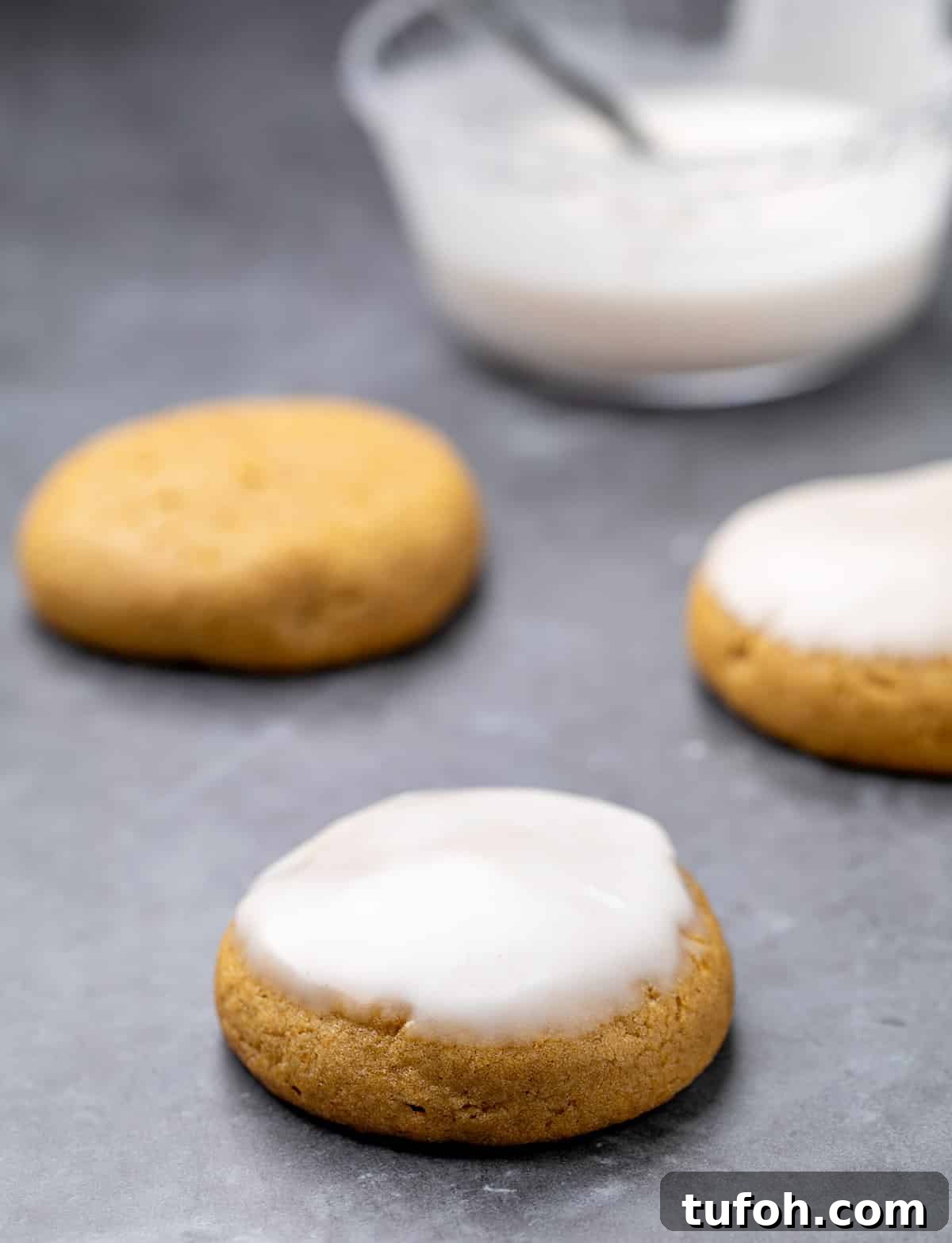 Gluten-Free Pumpkin Cookie Recipe: Soft, Chewy Fall Treat 8 Pumpkin cookies with icing and without with bowl of icing in background.