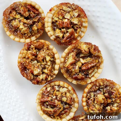 mini pecan pies on a serving platter.