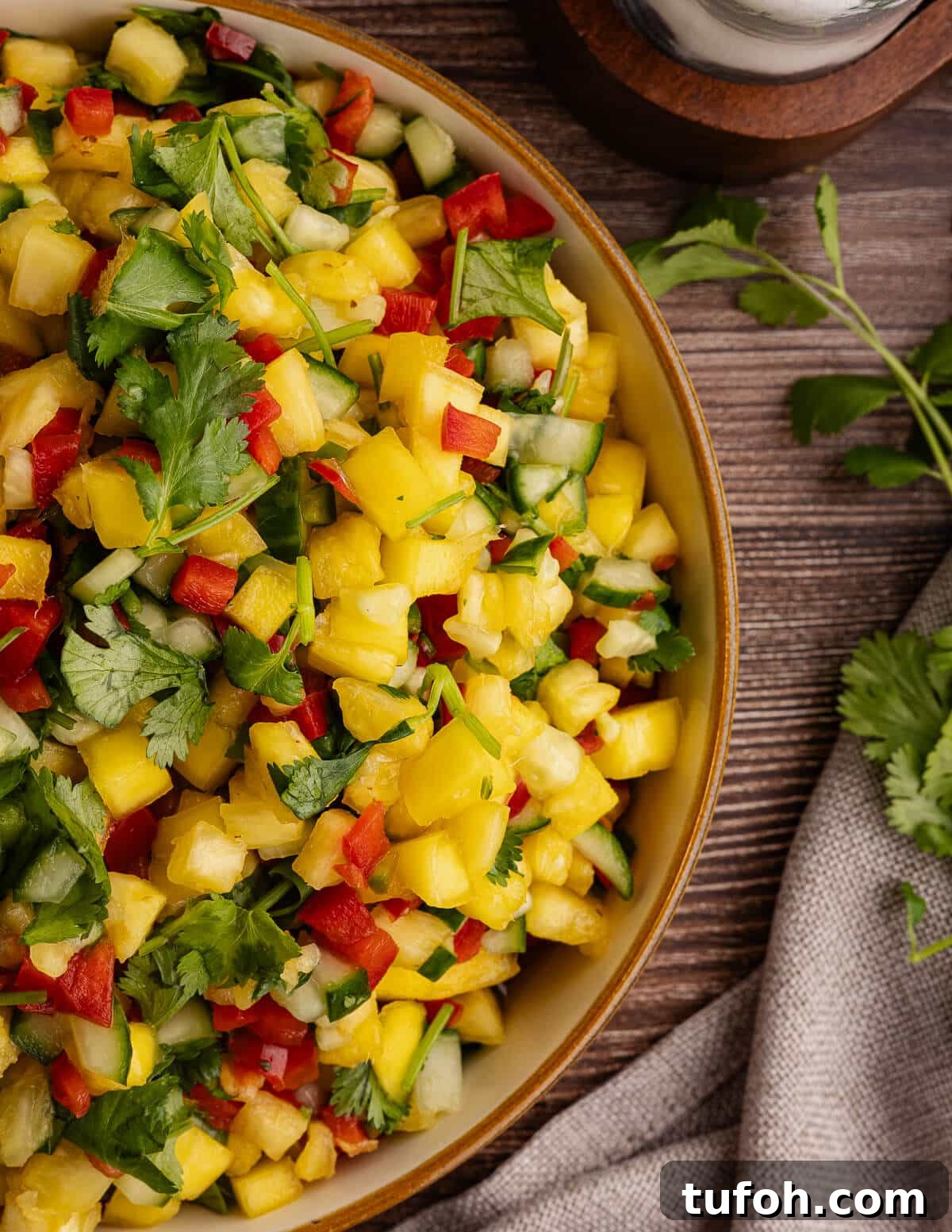 Tangy Pineapple Mango Salsa Recipe for Grilled Fish & Tacos 13 close up of pineapple mango salsa in a bowl.