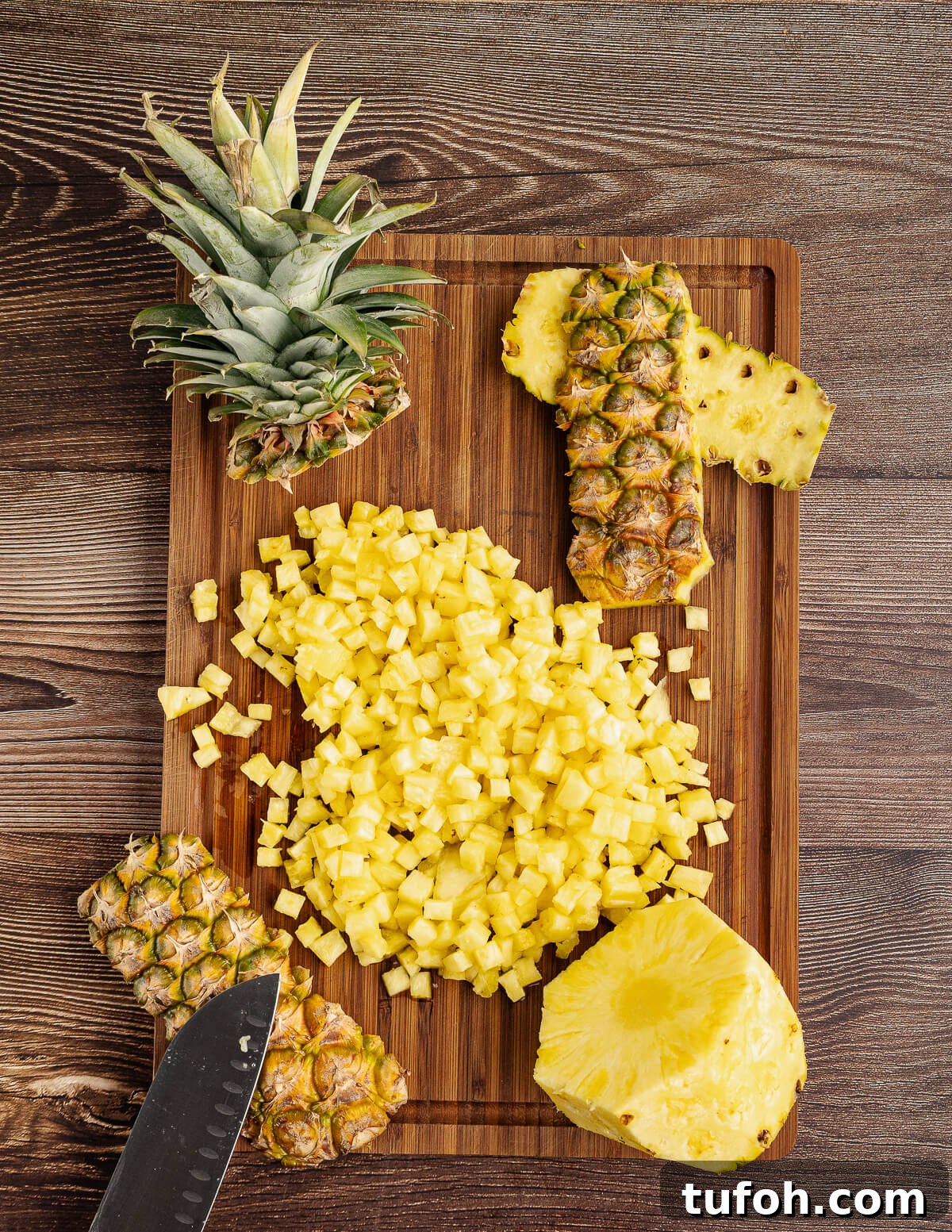 Tangy Pineapple Mango Salsa Recipe for Grilled Fish & Tacos 5 small diced pineapple on a cutting board.