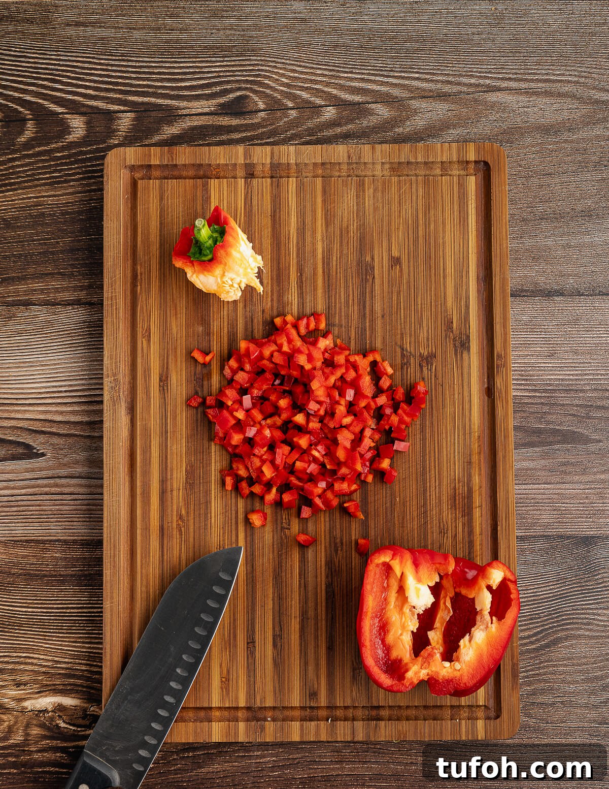 Tangy Pineapple Mango Salsa Recipe for Grilled Fish & Tacos 6 diced red bell pepper on a cutting board.