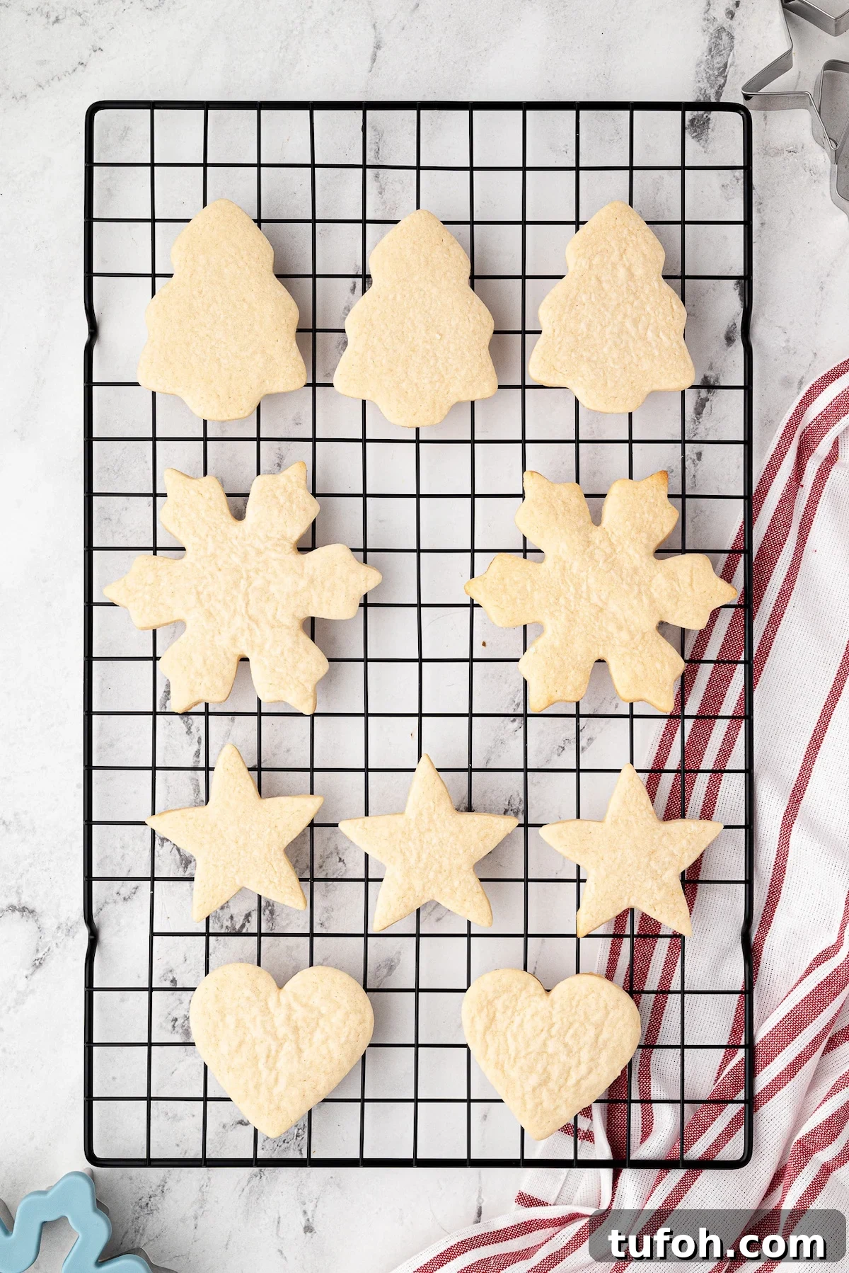 Soft Cut-Out Sugar Cookies Recipe for Tender, Perfect Shapes 2 Baked cut out cookies in assorted shapes on a wire rack.