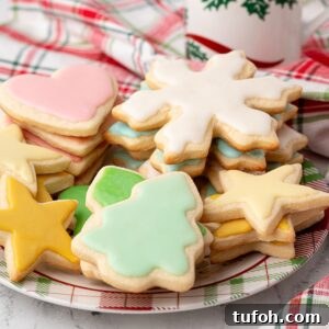 Soft Cut-Out Sugar Cookies Recipe for Tender, Perfect Shapes 10 plate of assorted cut out and frosted Christmas sugar cookies