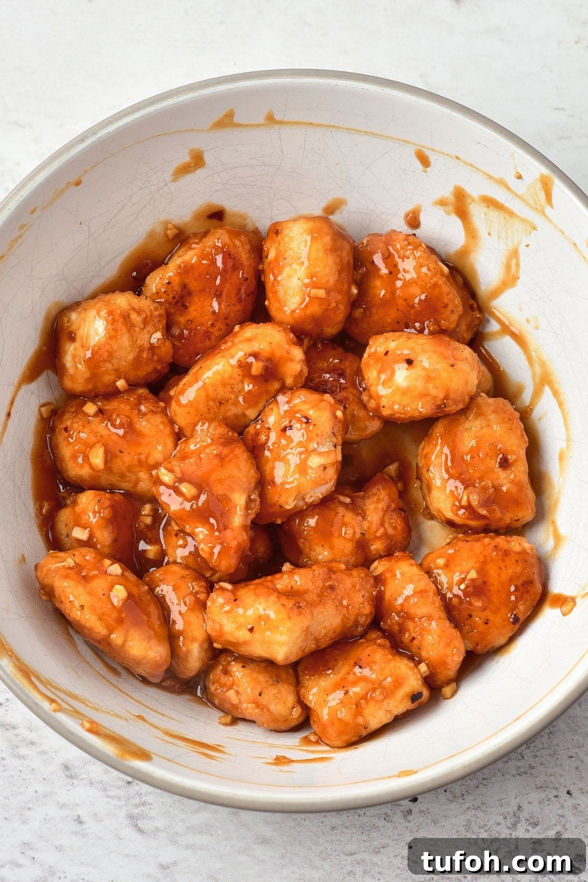 Korean-Style Fried Chicken (Gluten-Free, Dairy-Free) Tossing fried battered chicken in red sauce
