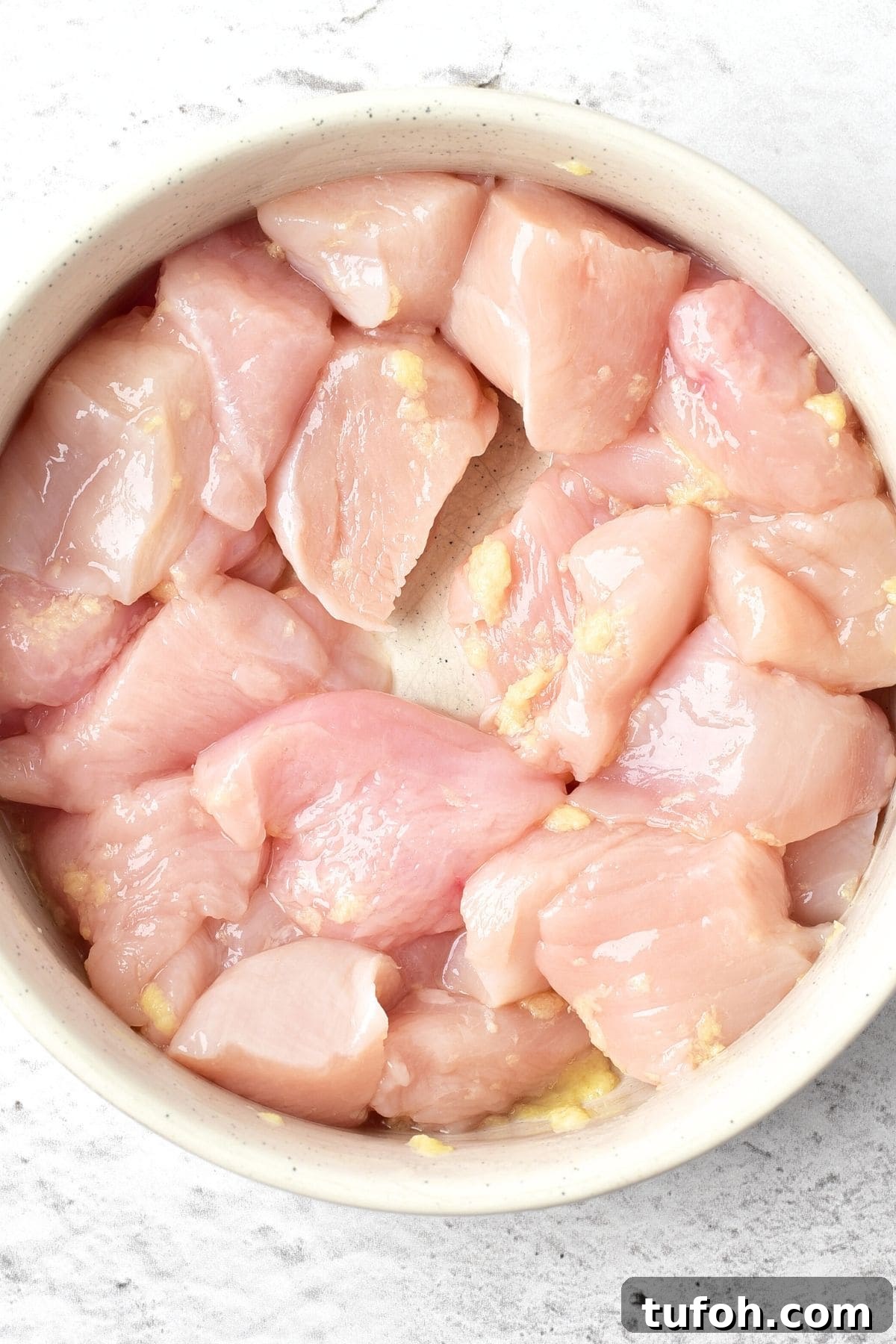 Korean Fried Chicken Recipe (Gluten-Free, Dairy-Free) Marinating chicken pieces in bowl