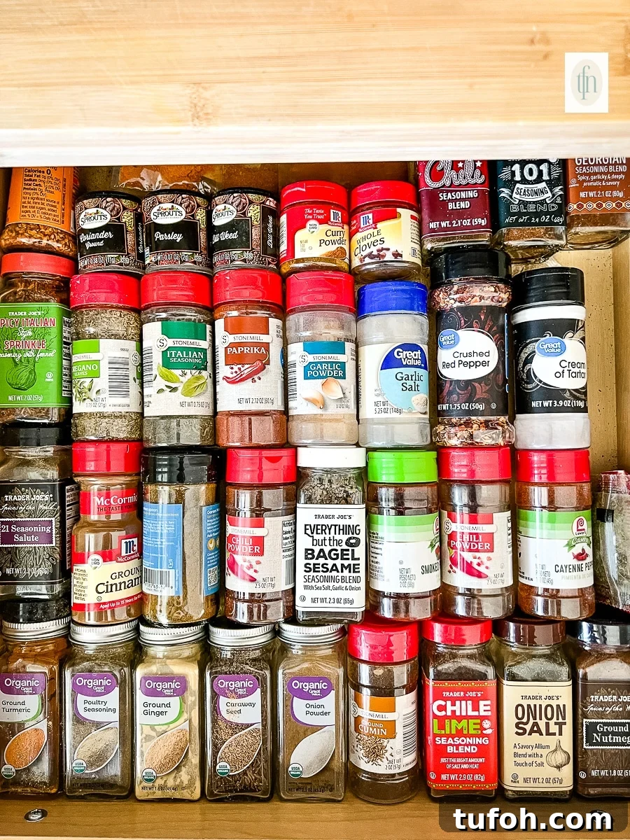 Old bottles of expired spices in a spice cabinet.