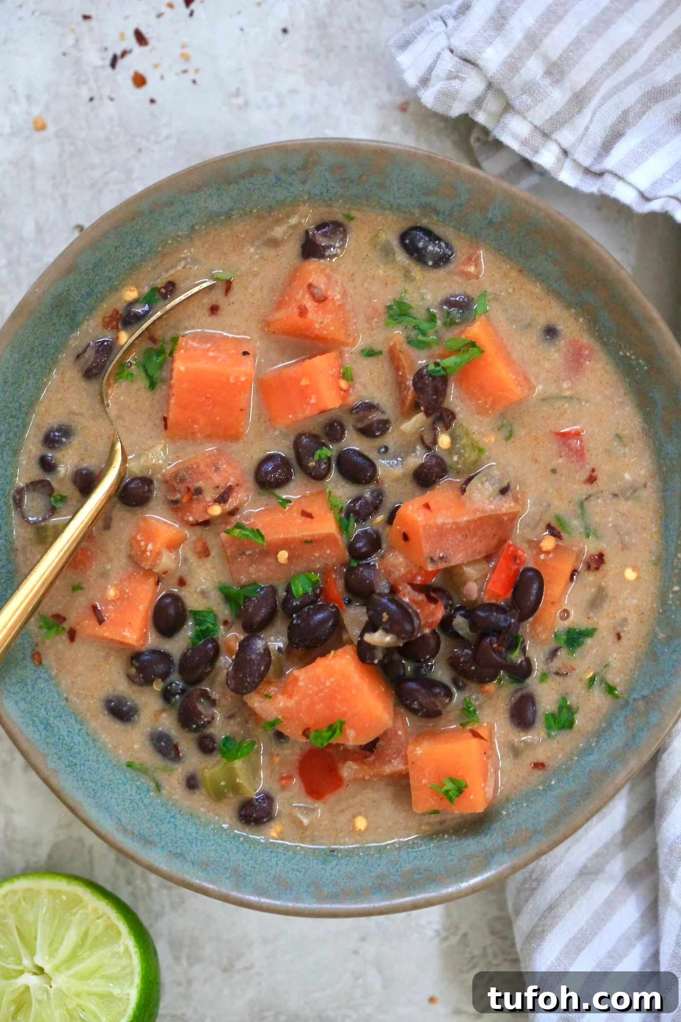 Creamy Dairy-Free Sweet Potato and Black Bean Soup Recipe 2 bowl of black bean soup with sweet potatoes and spoon