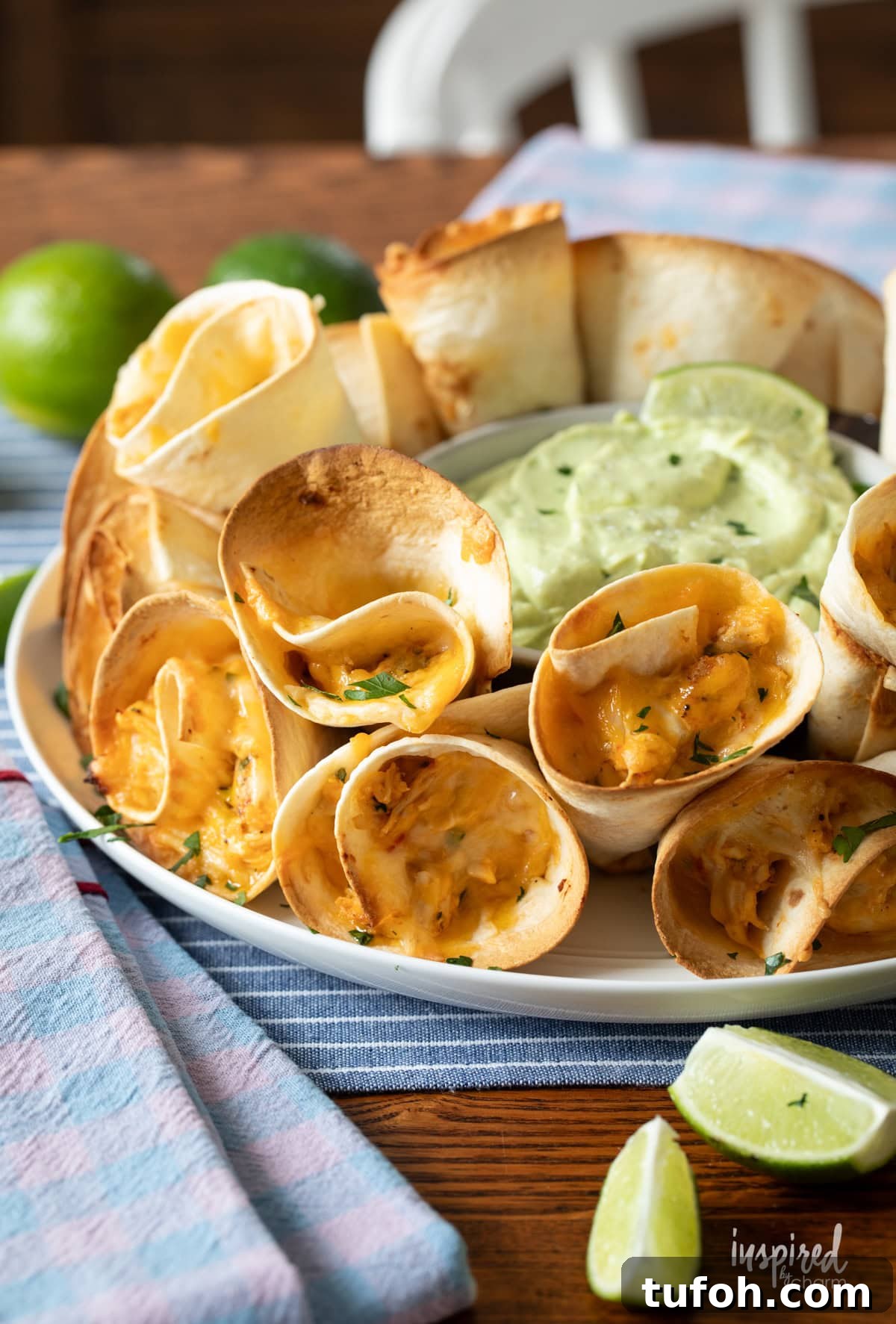 Cheesy Quesadilla Dipper Recipe: Crispy, Gooey Snack Idea 2 Cheesy Quesadilla Dippers on a plate with dipping sauce and limes.
