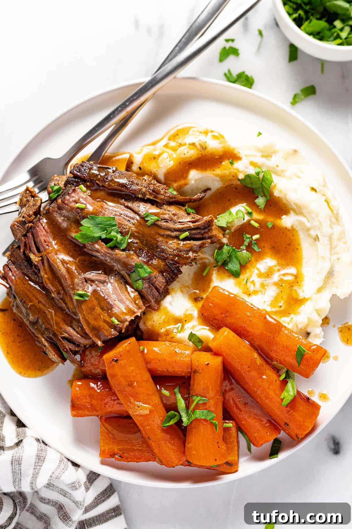 Slow-Cooker Pot Roast with Rich Homemade Gravy 9 Small plate with mashed potatoes, carrots, and slow cooker pot roast.