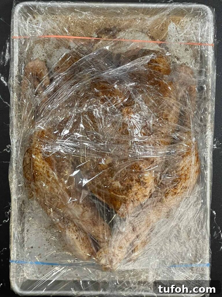 Perfect Whole Smoked Turkey: Year-Round Smoking Guide 6 A dry brined raw turkey on a baking sheet.