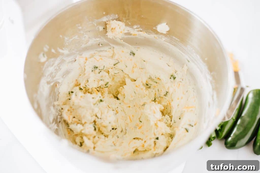 seasoned cream cheese filling in a metal mixing bowl