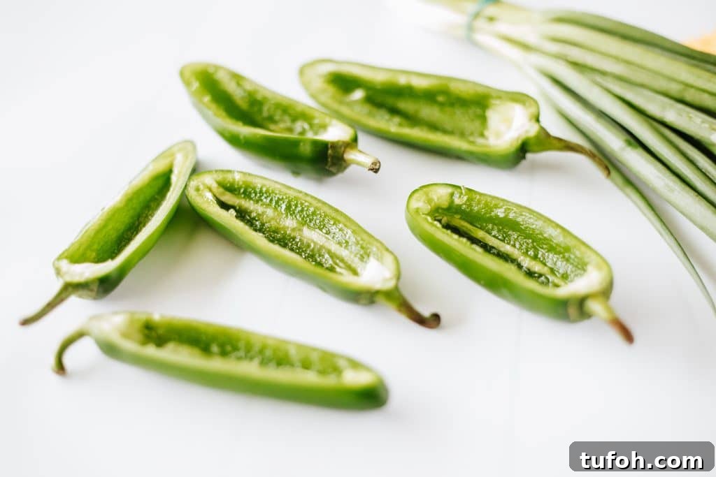 hollowed out jalapeno halves on a white coutnertop