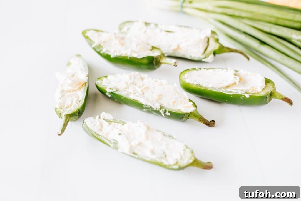 cream cheese filled jalapeno halves on a white countertop