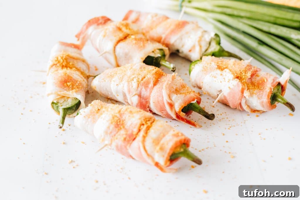 bacon wrapped jalapeno poppers on a white counter top