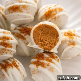 Close up of halved pumpkin cheesecake bite.