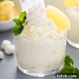 Close up image of pineapple fluff in a glass bowl.