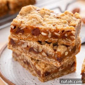Three stacked caramel pecan bars.