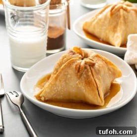 Plated old-fashioned apple dumpling with more apple dumplings in the background