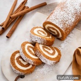 Sliced pumpkin roll on a marble board.