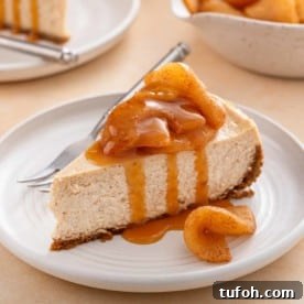 Plated slice of caramel apple cheesecake next to a fork.