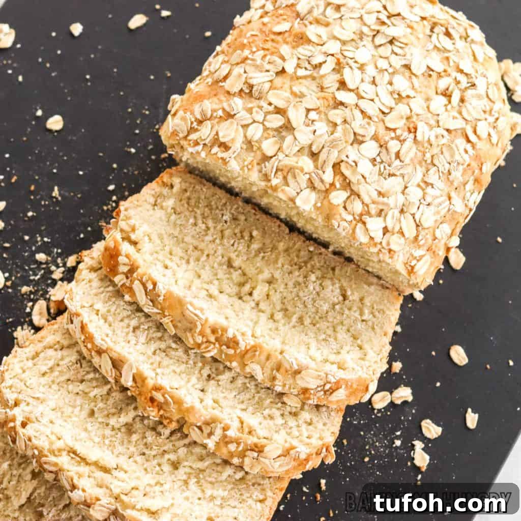 Homemade Oat Bread Recipe: Soft, Nutty Loaf You Can Bake at Home 2 slices of oat bread showing interior crumb and oatmeal topping