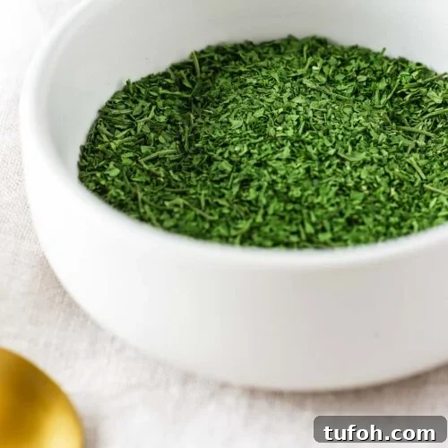Oven-Dried Parsley: A Simple Guide for Long-Lasting Flavor 10 A small white ceramic bowl with oven dried parsley.