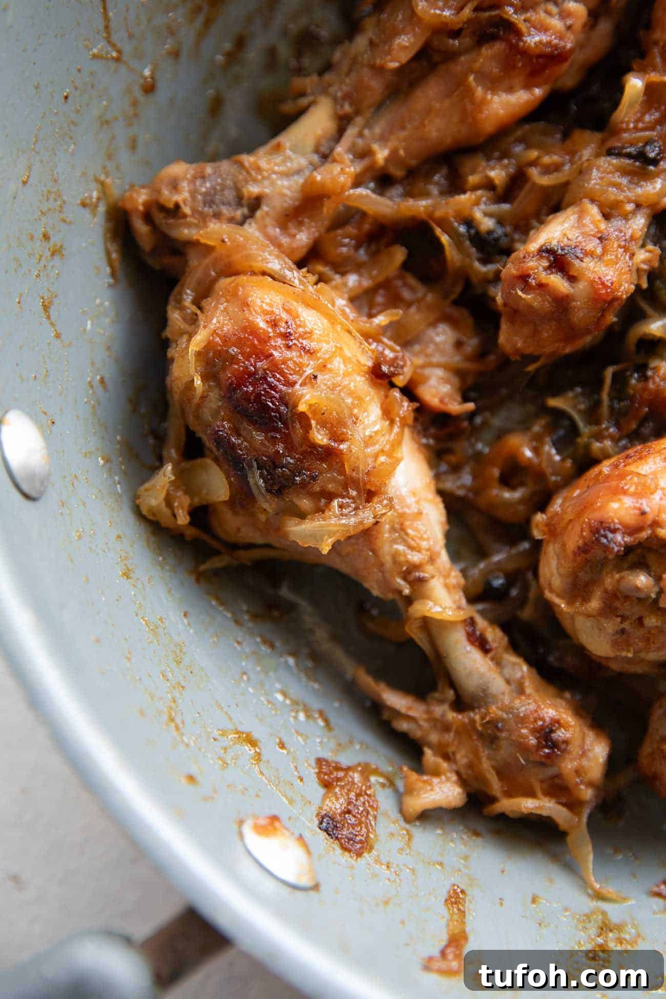 Chicken with caramelized onions in a pan