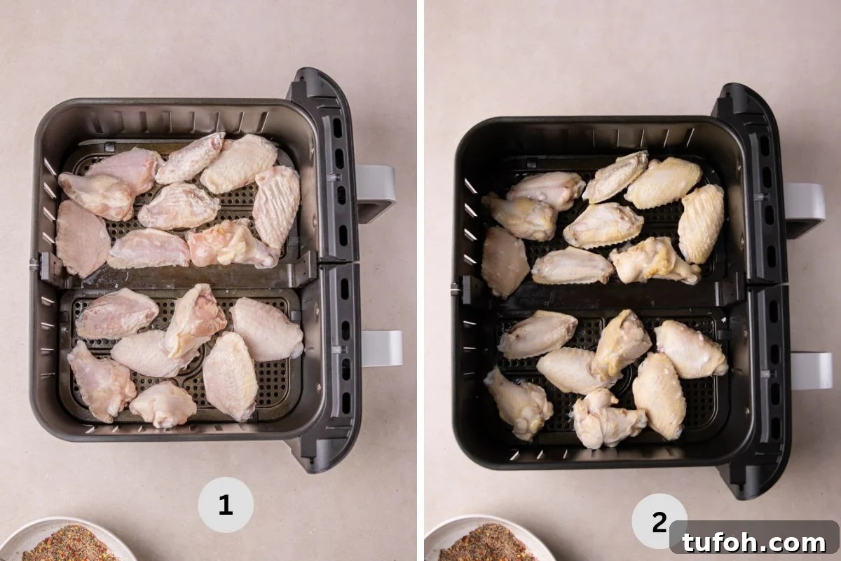 Air Fryer Frozen Chicken Wings (Cook Without Thawing) 5 Frozen wings in the basket of an air fryer getting thawed.