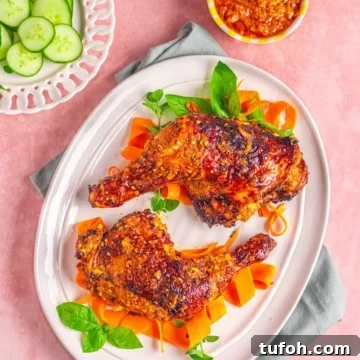 chicken peri peri on a white plate with vegetables.