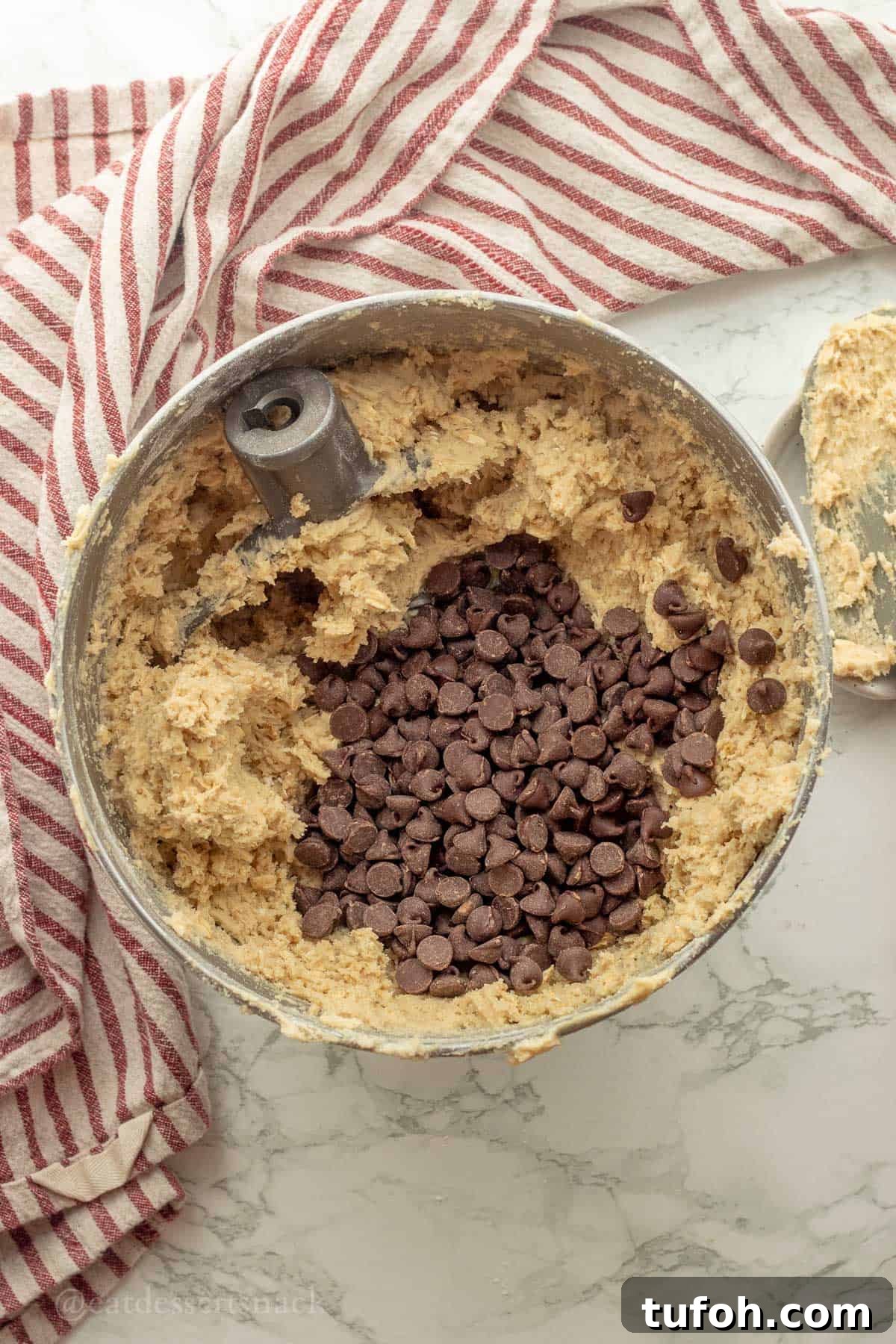 Chewy Sourdough Oatmeal Cookies with Brown Butter 8 Chocolate chips in bowl of raw sourdough oatmeal cookie dough in metal mixing bowl.