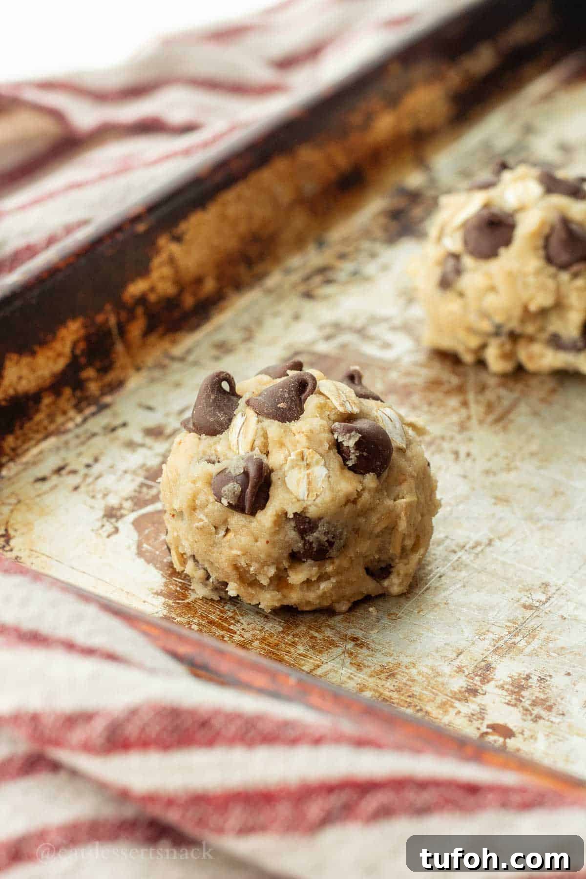 Chewy Sourdough Oatmeal Cookies with Brown Butter 9 Raw cookie dough ball on metal baking sheet.