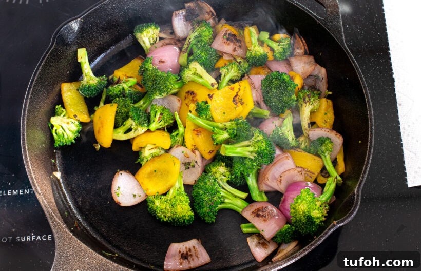 Stir fry vegetables in a skillet.