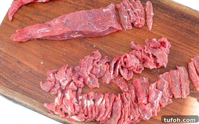 Sliced flank steak on a cutting board.