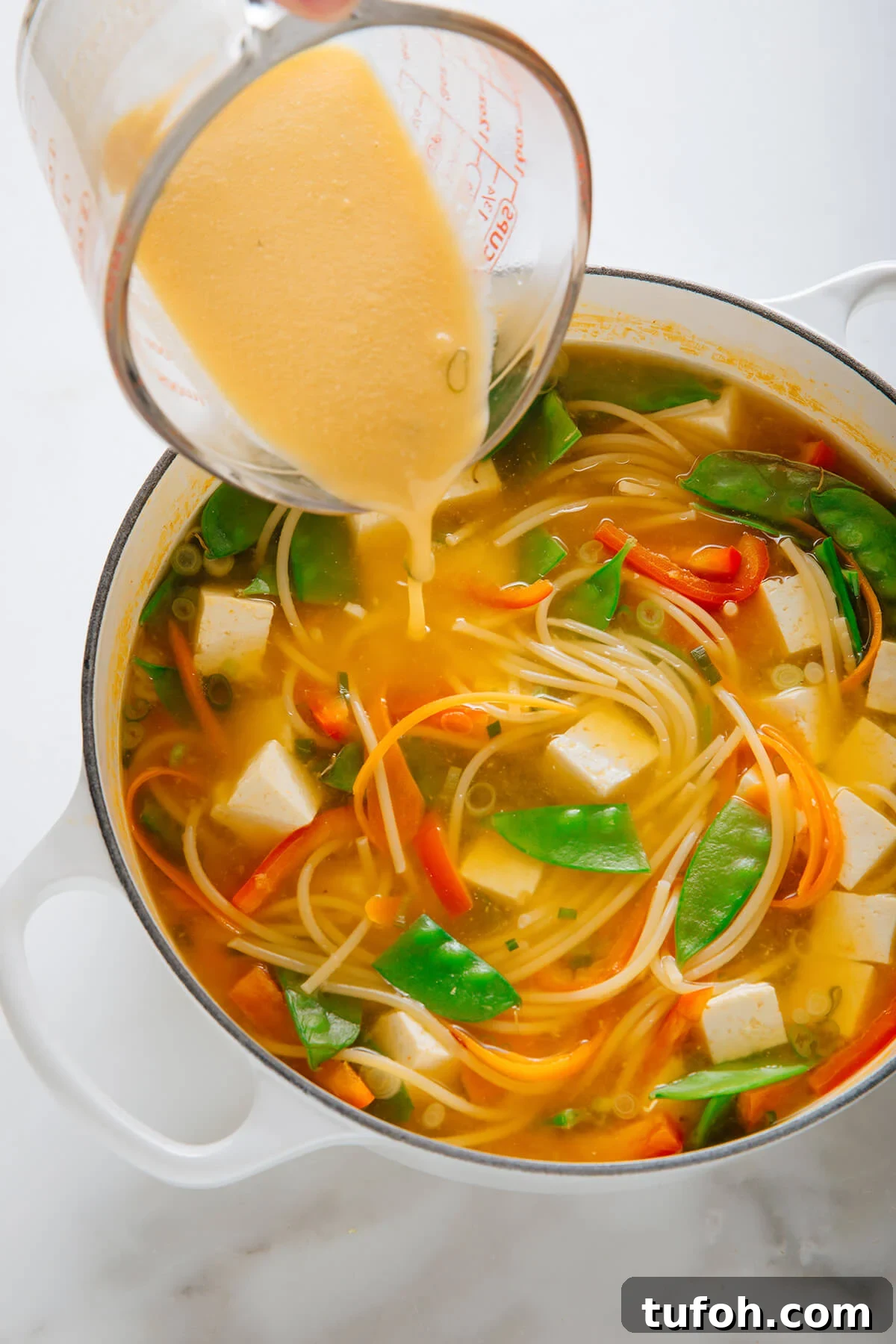 pouring miso mixture into soup