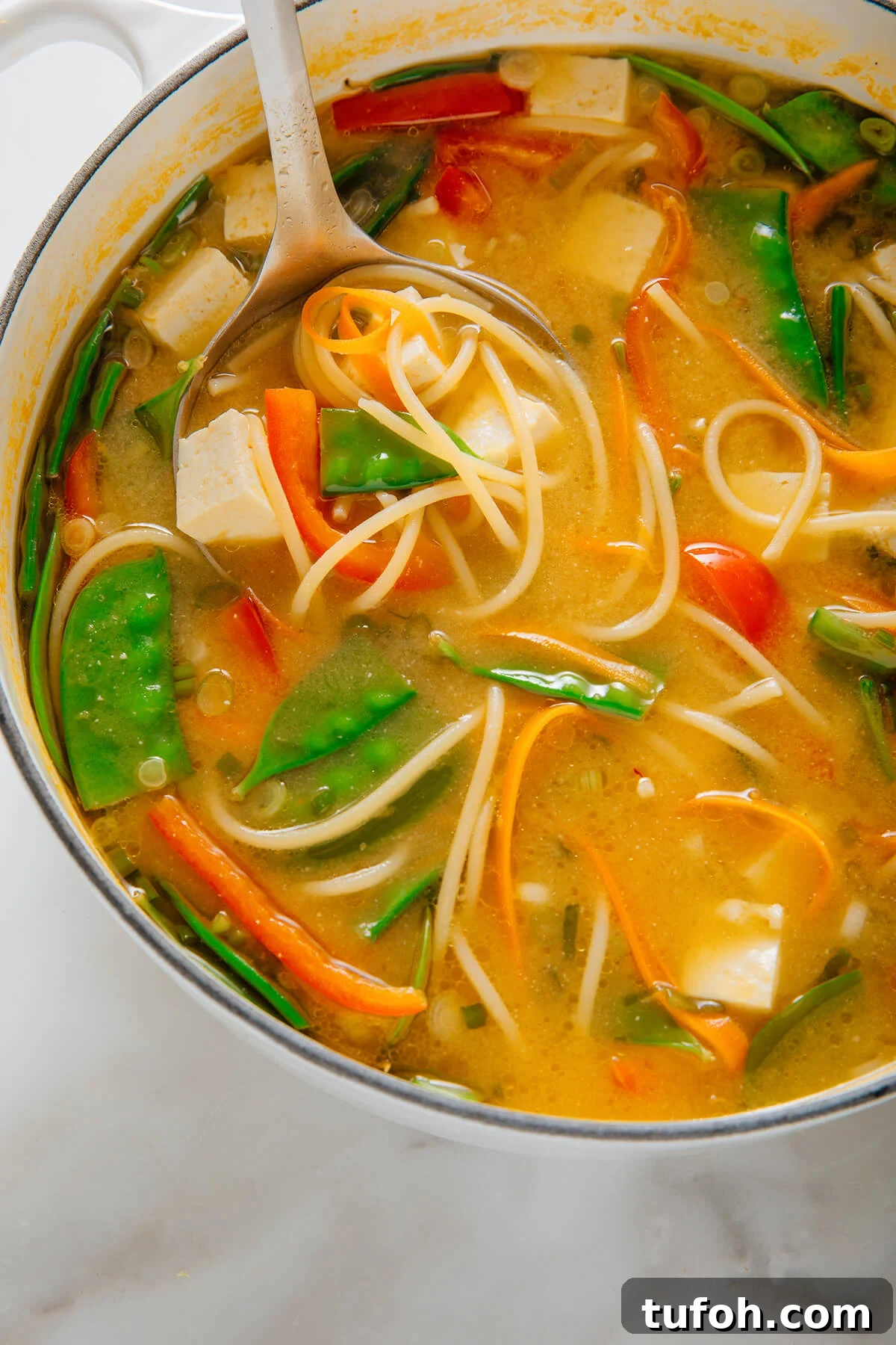 ladle of miso noodle soup