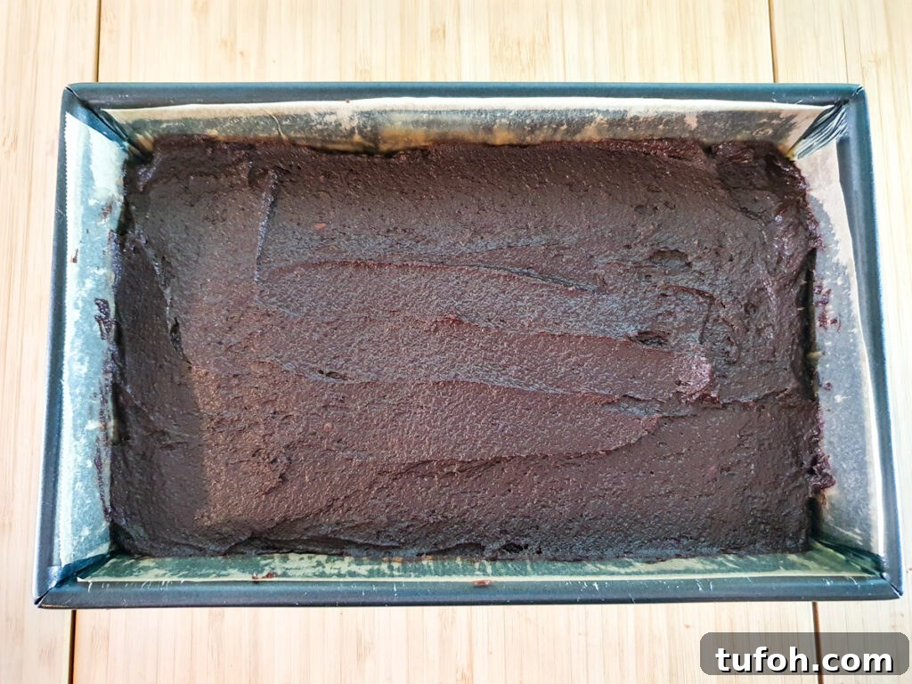 Decadent Egg-Free Brownies: Fudgy, Moist Recipe 12 Smoothing batter into lined brownie tin.