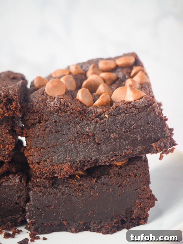 Decadent Egg-Free Brownies: Fudgy, Moist Recipe 17 Close up side view of short stack of eggless brownies.