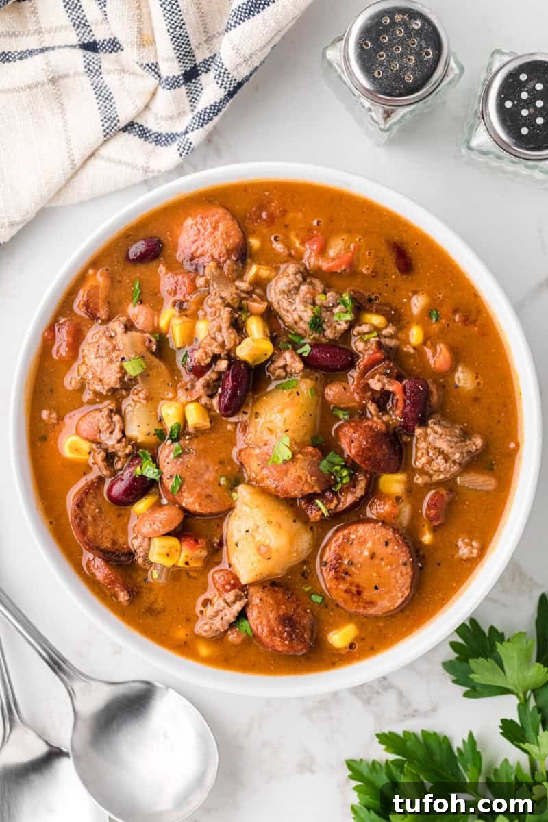 Hearty Cowboy Stew Recipe: Classic Beef and Bean Dinner 2 top-down view of Cowboy Stew in white bowl.