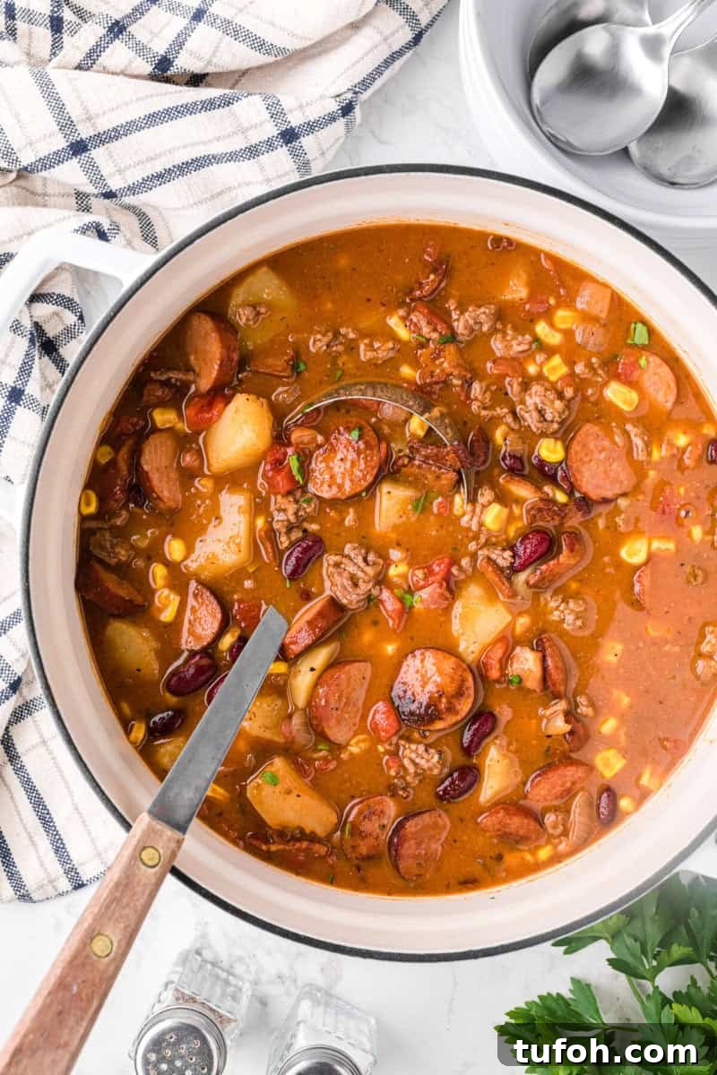 Hearty Cowboy Stew Recipe: Classic Beef and Bean Dinner 11 top-down view of the Cowboy Stew being served with a ladle.